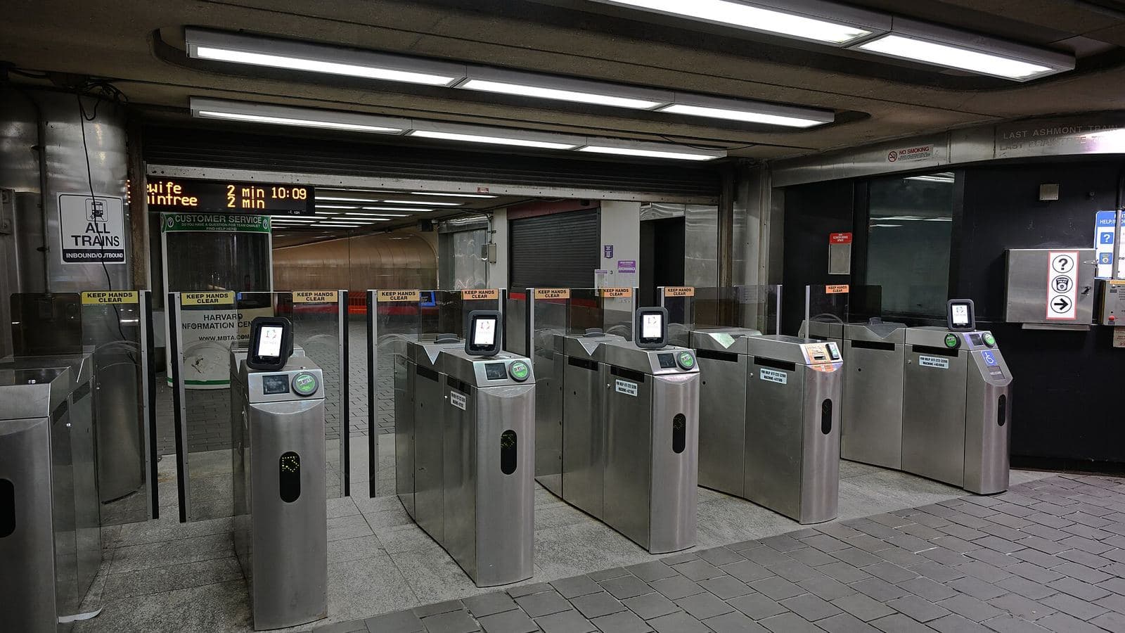 A row of station fare gates fitted with contactless card readers