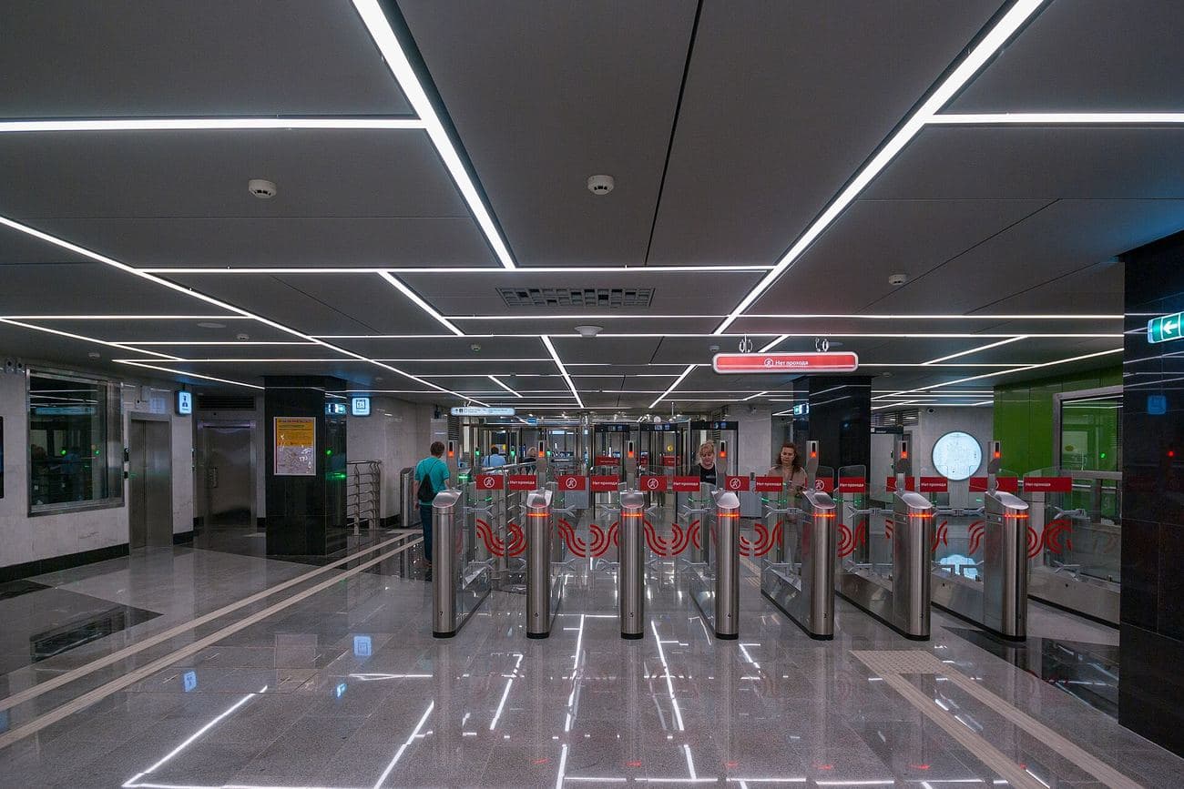 A station concourse lined with ticket barriers